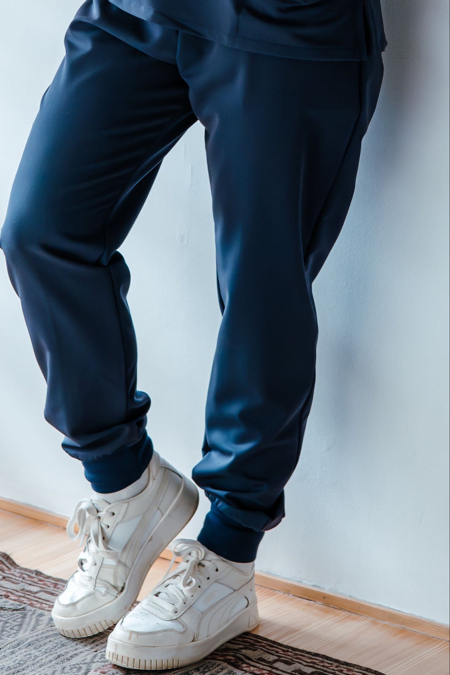 Housekeeper wearing Navy workwear top and jogger uniform pants